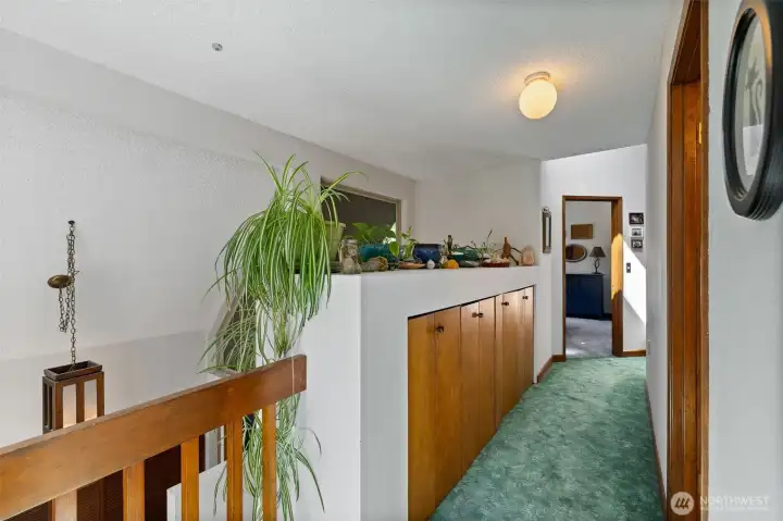 Upper level hall way to Primary suite, and 2 more bedrooms and full bath