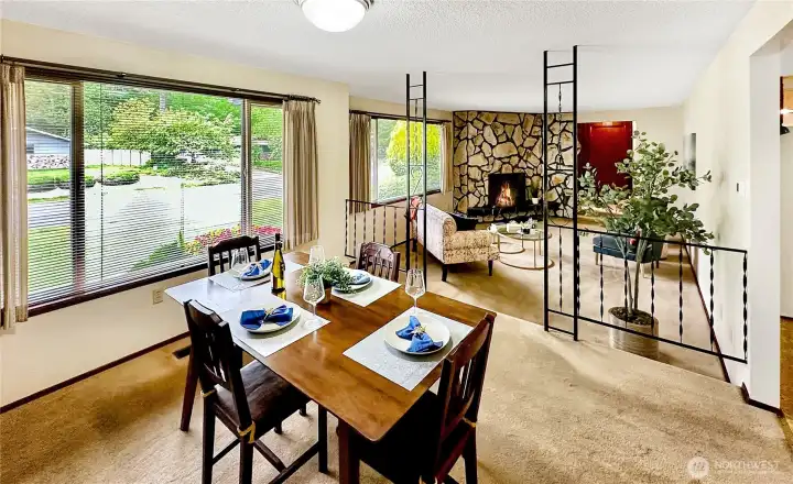 Formal dining room with wall-papered accent wall and west facing sunny window.