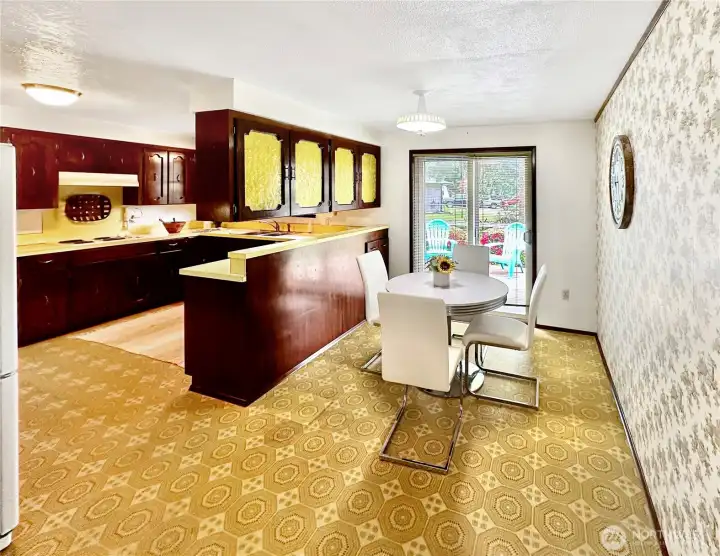 U-shaped kitchen with plenty of counter space and cabinets plus adjoining breakfast room with slider access to the composite sundeck and backyard.