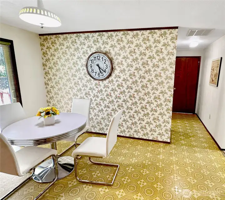 This shows the breakfast room and the door to garage.  The laundry room is behind the wall papered wall.