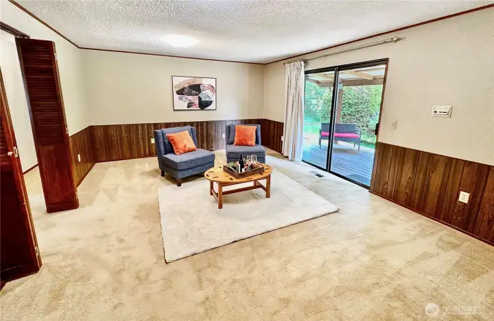 The family is centrally located off both the entry way and kitchen with slider door that opens to the covered rear deck and backyard and double doors that separate the room from the entry way.