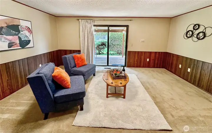 Another view of the family room shows the wood paneling wainscotting.