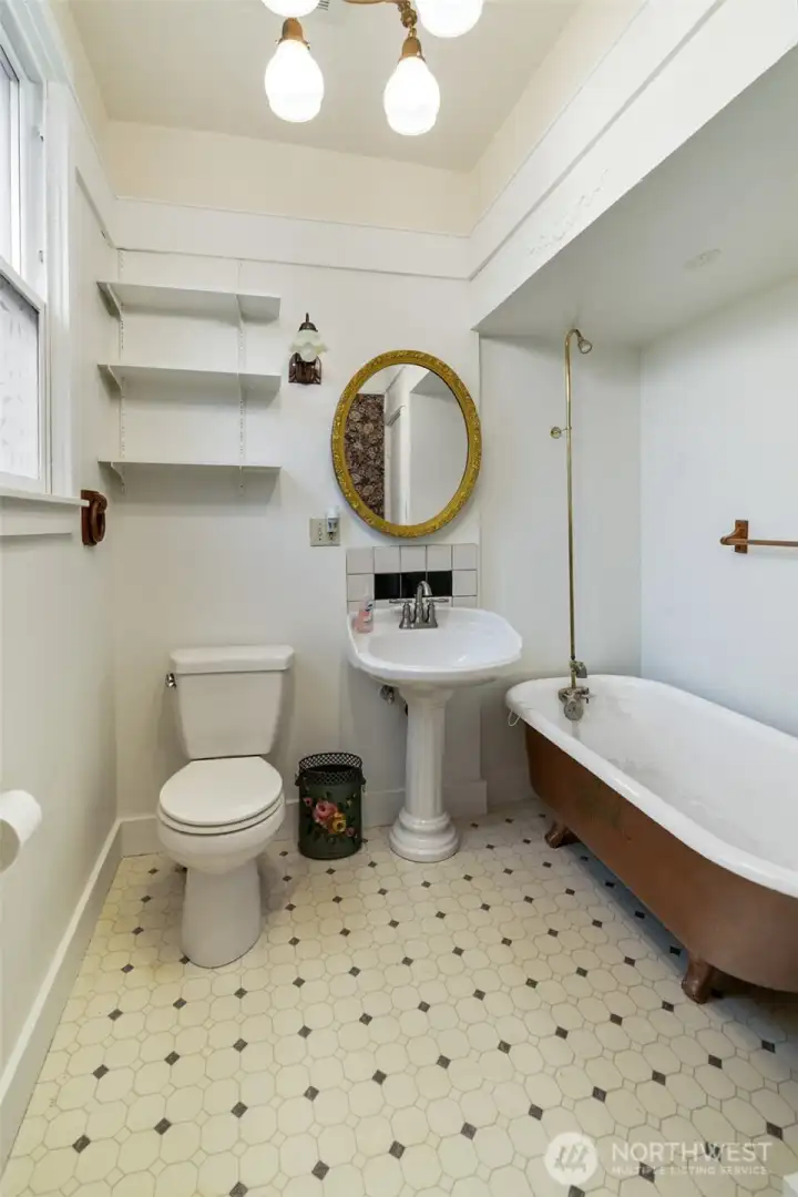 The interior retains original 1908 character, including tall ceilings, historic wood details, and a vintage clawfoot tub in the main bathroom.  Don't miss the chandelier.