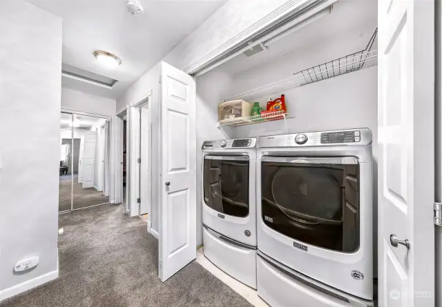 Upper level Laundry Area with washer/dryer set and drawers.