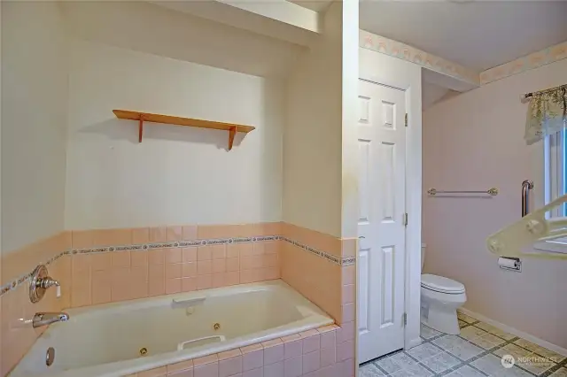 Primary bath is five piece with the shower around the corner..
