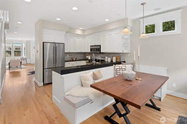 This crisp, remodeled kitchen features stainless appliances and generous counter space—plus built-in seating that’s as practical as it is charming.