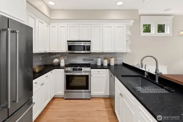 Bright, fresh, and functional—this well-appointed kitchen features handsome, honed granite counters, stainless appliances, and plenty of storage for your culinary essentials.