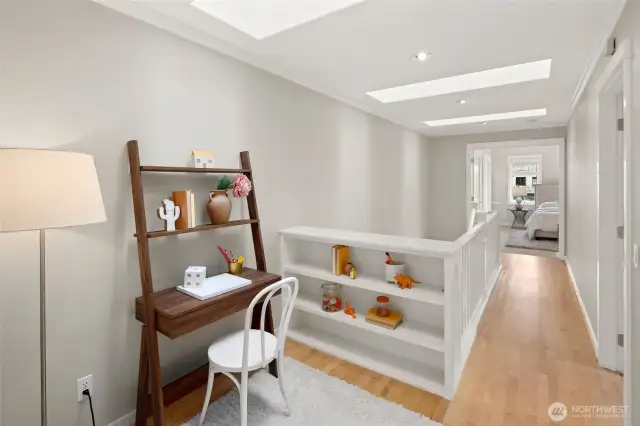 Skylit and serene, this open landing is a dream spot for a tucked-away homework station, craft zone, or peaceful reading nook.