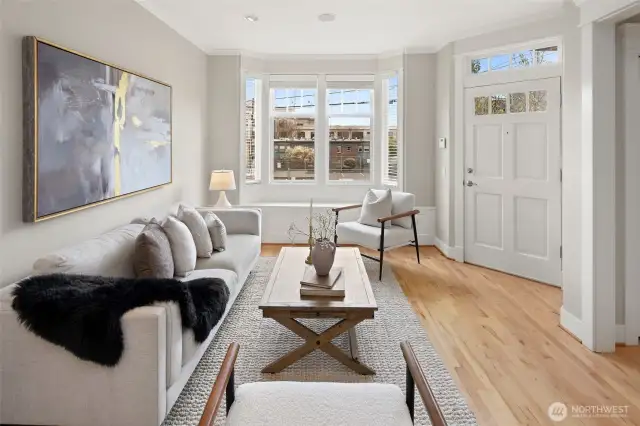 Soak up natural light from the bay windows in this inviting living room—perfect for morning coffee or winding down in the evening.