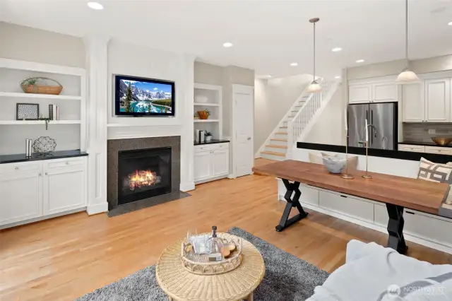 Cozy up by the gas fireplace in the heart of the home, flanked by built-ins that offer stylish display space and abundant hidden storage. A perfect blend of warmth, function, and charm.
