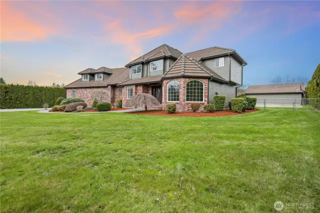 Side view of home with gate to backyard sports court