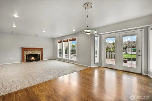 New carpet in living room with wood fireplace