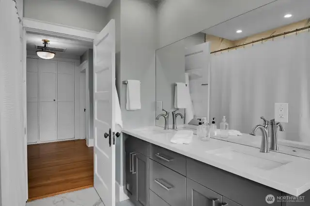 Pristine upstairs bathroom with direct access to the primary and to the landing.