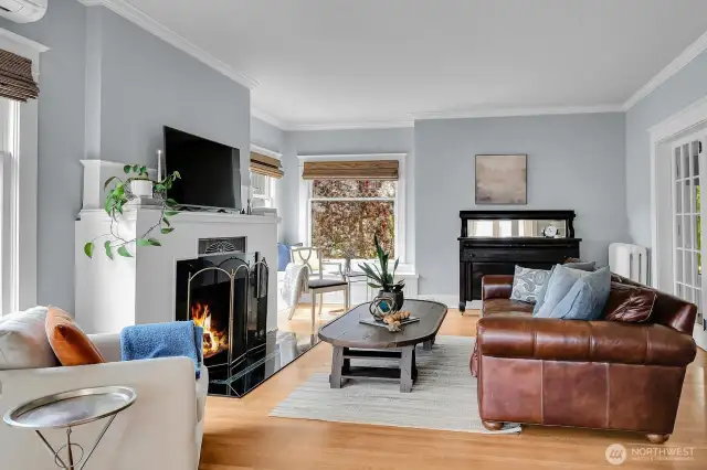 Original quarter-sawn oak floors and a wood fireplace. Note the mini split over window to the left. Yes we have AC!