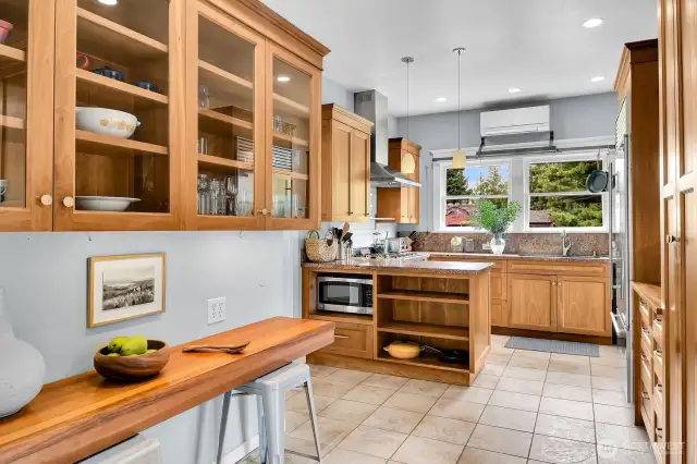 A well thought out command center for the chef in your household. Note the pot rack over the window and the mini split for toasty summers. At left is the perfect homework area...