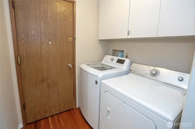 Utility room with storage and access to the garage.