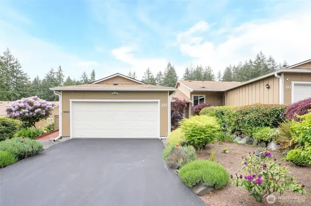 Two car garage with built-in storage selves.  Plenty of parking for additional guests.