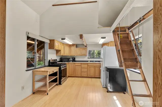 Large kitchen area has room for a corner table too! Drop down ladder here accesses the bonus room space above.