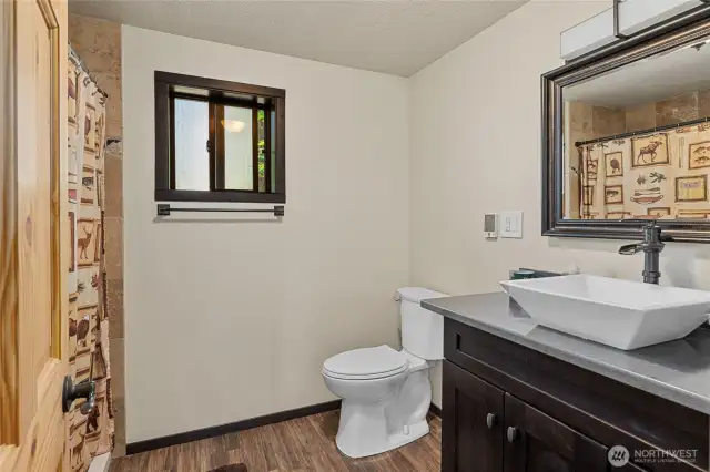 Main floor 3/4 awesome bath with showerhead + rainshower + jets! Heated tile floor & pretty vessel sink.
