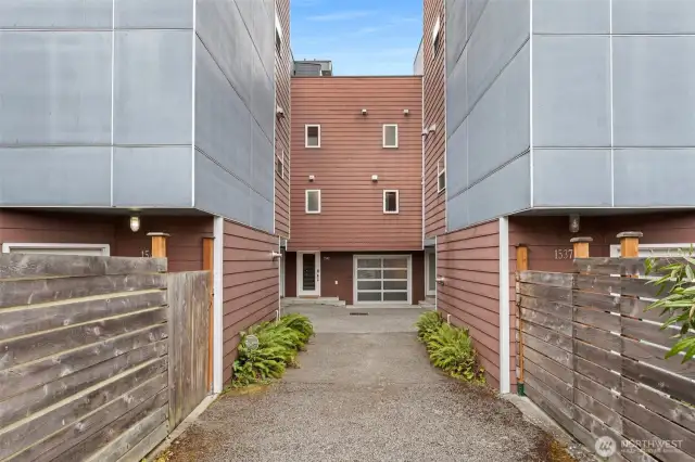 Front exterior, entrance tucked back from street for privacy.