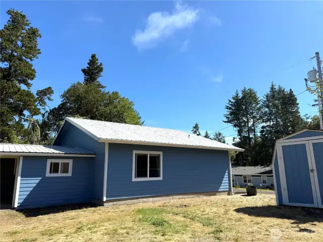 Side of house with bunk house with toilet and washer dryer hook up
