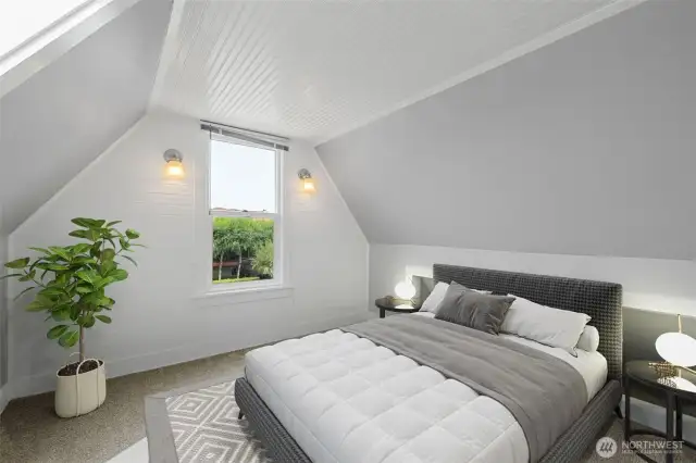 Bedroom #2 features decorative wainscoting and a view of Commencement Bay. Photo Virtually Staged