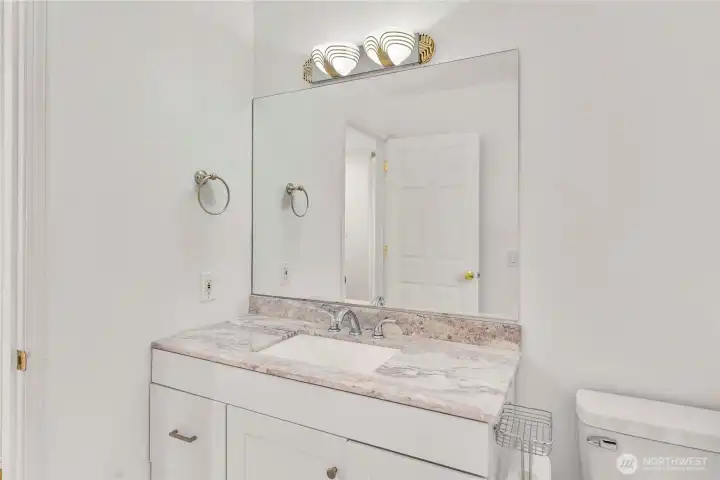 Guest bathroom with new shower door, new toilet and new flooring