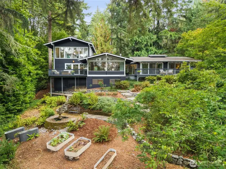 Rear of the house with charming garden beds.