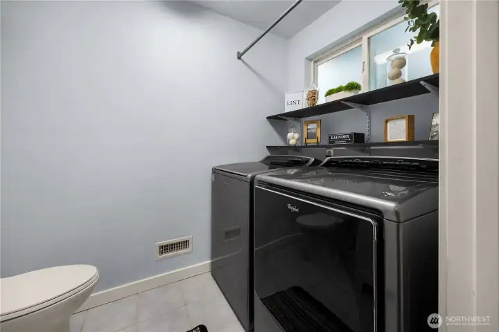 Lower level half bathroom has washer and dryer hookups