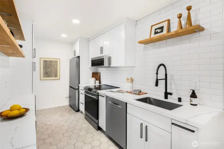 Full kitchen renovation in 2021 features; heater floor, Quartz counters, sleek cabinetry and new stainless steel appliances.