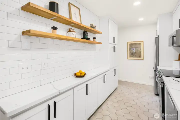 Full kitchen renovation in 2021 features; heater floor, Quartz counters, sleek cabinetry and new stainless steel appliances.