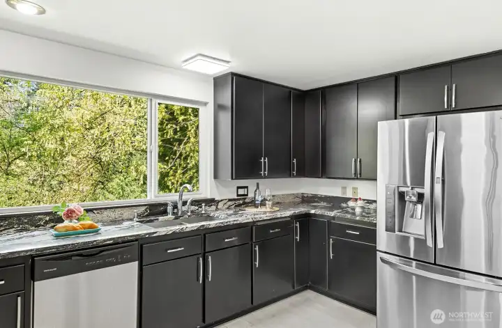 Redesigned gourmet kitchen with stainless appliances.