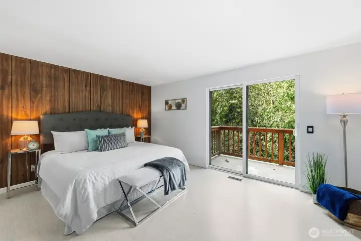 Primary suite features sliding glass door to a private deck.