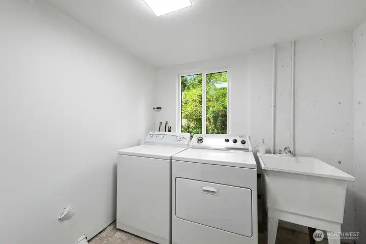 Utility room with deep tub.  Washer and dryer stay with the home.