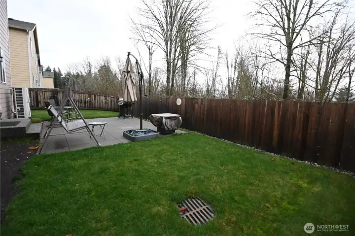 Immaculate green lawn complemented by the patio and side garden area (not pictured).