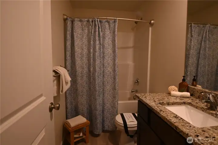 Full bath with granite counter.