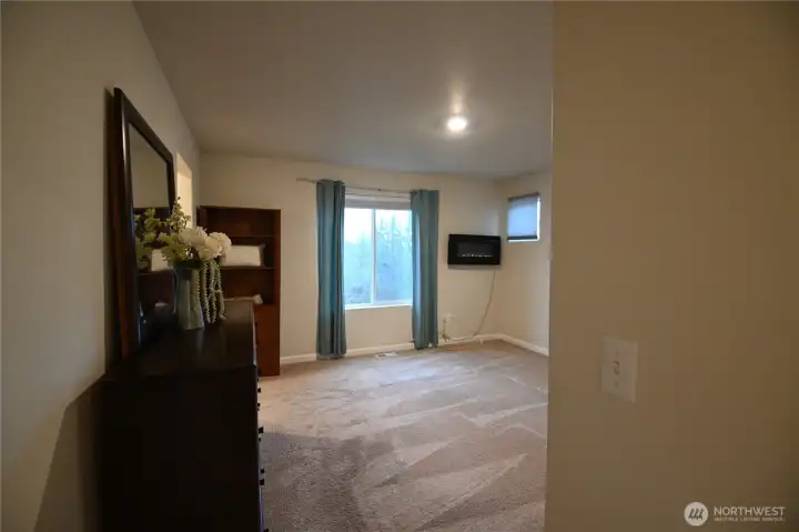 Primary boasts deep walk-in closet & electric wall-mount fireplace.