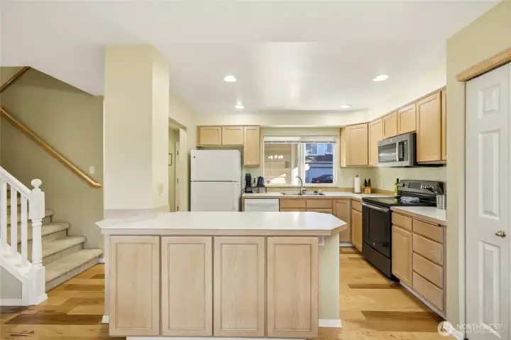 Kitchen with ample cabinetry and front-facing window.
