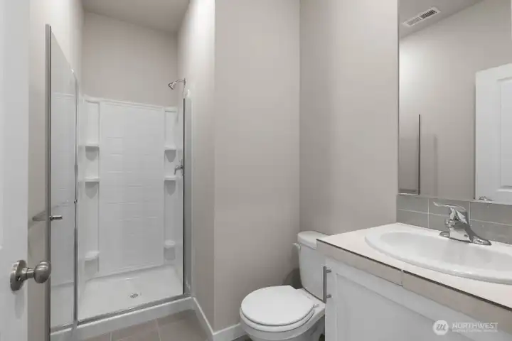 Main floor 3/4 bath.  Colors and finishes may vary.