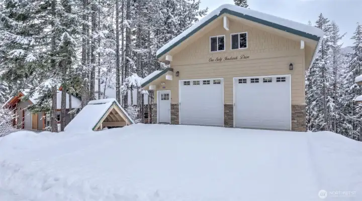 Large level driveway leading to newly built garage.