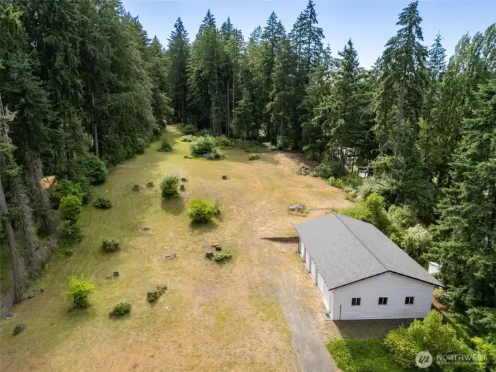 Now the compound potential really starts to reveal itself. This aerial looks over the impressive four-bay shop and beyond to the additional acreage stretching all the way toward Carpenter Road, illustrating why properties like this are becoming increasingly difficult to find. With two separate parcels totaling 4.584 acres, there's room here for big ideas, future possibilities and the kind of flexibility most waterfront properties simply can't offer. The shop already provides an incredible foundation for collectors, hobbyists, entrepreneurs or anyone needing serious storage and workspace, while the land beyond invites endless imagination. Even better, the included riding mower and ATV help make ownership of this expansive property both practical and fun. Now the compound potential really starts to reveal itself. This aerial looks over the impressive four-bay shop and beyond to the additional acreage stretching all the way toward Carpenter Road, illustrating why properties like this are becoming increasingly difficult to find. With two separate parcels totaling 4.584 acres, there's room here for big ideas, future possibilities and the kind of flexibility most waterfront properties simply can't offer. The shop already provides an incredible foundation for collectors, hobbyists, entrepreneurs or anyone needing serious storage and workspace, while the land beyond invites endless imagination. Even better, the included riding mower and ATV help make ownership of this expansive property both practical and fun.