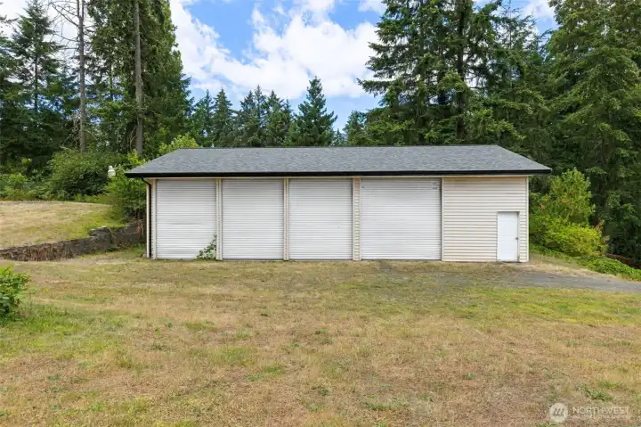 Set apart from the main residence with abundant turnaround space surrounding it, this massive four-bay outbuilding has the breathing room needed for trailers, equipment, recreational vehicles, projects and everyday use without constantly negotiating around the house. The new composition roof crowns the structure beautifully, while the combined 4.6-acre footprint created by two included parcels gives the entire property an expansive, wide-open feel. Set apart from the main residence with abundant turnaround space surrounding it, this massive four-bay outbuilding has the breathing room needed for trailers, equipment, recreational vehicles, projects and everyday use without constantly negotiating around the house. The new composition roof crowns the structure beautifully, while the combined 4.6-acre footprint created by two included parcels gives the entire property an expansive, wide-open feel.