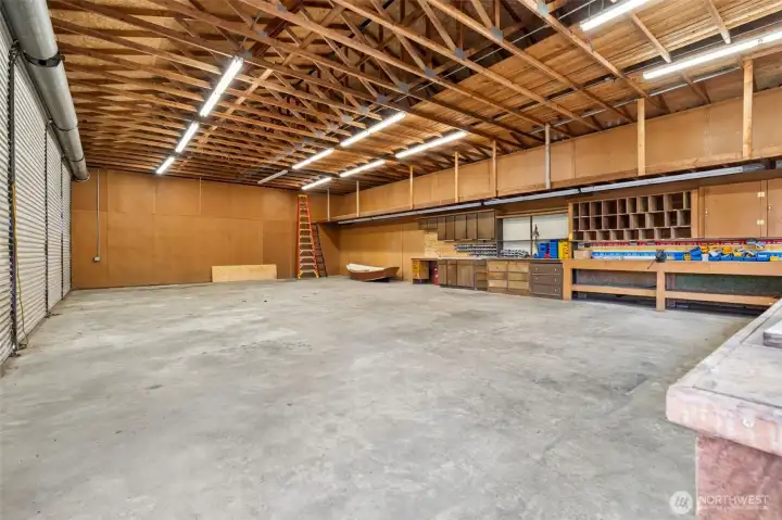 This massive four-bay metal shop is built to handle everything from vehicles and equipment to hobbies, projects and collections on a scale most properties simply can't accommodate. Four separate 12-foot roll-up doors provide exceptional access and flexibility, while recent electrical improvements add functionality and peace of mind. A dedicated workshop area is already in place with extensive storage cabinetry, and above it all, an expansive upper storage platform stretches nearly the entire length of the building, creating room for tools, seasonal equipment and supplies without sacrificing valuable floor space below. This massive four-bay metal shop is built to handle everything from vehicles and equipment to hobbies, projects and collections on a scale most properties simply can't accommodate. Four separate 12-foot roll-up doors provide exceptional access and flexibility, while recent electrical improvements add functionality and peace of mind. A dedicated workshop area is already in place with extensive storage cabinetry, and above it all, an expansive upper storage platform stretches nearly the entire length of the building, creating room for tools, seasonal equipment and supplies without sacrificing valuable floor space below.