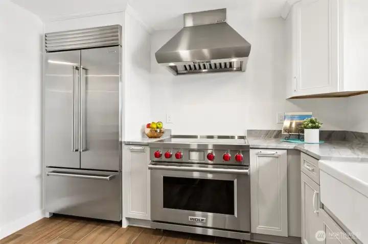 Chef's kitchen? People throw that phrase around a lot. This one actually earns it. Front and center is a premium Wolf cooking suite paired with a substantial vent hood that looks every bit as impressive as it performs, while the Sub-Zero refrigerator stands ready to keep ingredients fresh for your next culinary masterpiece. Together, these luxury appliances represent the kind of quality most buyers dream about and rarely find already installed. Add beautiful quartz counters, timeless shaker cabinetry and a layout designed around both cooking and entertaining, and you've got a kitchen that's equally prepared for Thanksgiving dinner, wine-and-cheese nights or showing off a little when friends come over. Chef's kitchen? People throw that phrase around a lot. This one actually earns it. Front and center is a premium Wolf cooking suite paired with a substantial vent hood that looks every bit as impressive as it performs, while the Sub-Zero refrigerator stands ready to keep ingredients fresh for your next culinary masterpiece. Together, these luxury appliances represent the kind of quality most buyers dream about and rarely find already installed. Add beautiful quartz counters, timeless shaker cabinetry and a layout designed around both cooking and entertaining, and you've got a kitchen that's equally prepared for Thanksgiving dinner, wine-and-cheese nights or showing off a little when friends come over.