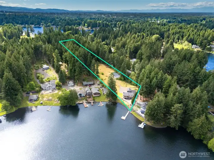 . Location matters, and this angle explains exactly why. Situated on the mainland side of Holmes Island Road, this property enjoys a rare advantage: the ability to own a much larger acreage footprint while still taking in the same gorgeous Long Lake views that make Holmes Island such a sought-after destination. Through the trees, you'll catch glimpses of Long Lake, while Hicks Lake sparkles in the distance beyond, creating a backdrop that constantly reminds you that you're living in one of Thurston County's premier lake communities. The result is a property that feels more like a private estate than a traditional waterfront lot, offering room to spread out, dream bigger and enjoy a level of flexibility that's increasingly hard to find anywhere around the lake. . Location matters, and this angle explains exactly why. Situated on the mainland side of Holmes Island Road, this property enjoys a rare advantage: the ability to own a much larger acreage footprint while still taking in the same gorgeous Long Lake views that make Holmes Island such a sought-after destination. Through the trees, you'll catch glimpses of Long Lake, while Hicks Lake sparkles in the distance beyond, creating a backdrop that constantly reminds you that you're living in one of Thurston County's premier lake communities. The result is a property that feels more like a private estate than a traditional waterfront lot, offering room to spread out, dream bigger and enjoy a level of flexibility that's increasingly hard to find anywhere around the lake.