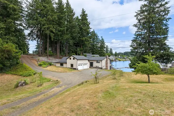 Included in the sale are two separate parcels totaling approximately 4.6 acres, creating opportunities that are becoming increasingly difficult to find on waterfront property. The main homesite occupies approximately .88 acres, while the additional 3.7-acre parcel expands the possibilities dramatically. Access between the parcels is already established, with driveway connections leading toward Holmes Island Road, Carpenter Road and the detached shop area. Whether you're envisioning a multigenerational setup, future guest accommodations, additional recreational space, gardens, workshops or simply the luxury of extra elbow room, this layout offers remarkable flexibility. Add lake access, multiple outbuildings and the absence of an HOA, and you've got a property where your imagination has far fewer restrictions than usual. Included in the sale are two separate parcels totaling approximately 4.6 acres, creating opportunities that are becoming increasingly difficult to find on waterfront property. The main homesite occupies approximately .88 acres, while the additional 3.7-acre parcel expands the possibilities dramatically. Access between the parcels is already established, with driveway connections leading toward Holmes Island Road, Carpenter Road and the detached shop area. Whether you're envisioning a multigenerational setup, future guest accommodations, additional recreational space, gardens, workshops or simply the luxury of extra elbow room, this layout offers remarkable flexibility. Add lake access, multiple outbuildings and the absence of an HOA, and you've got a property where your imagination has far fewer restrictions than usual.