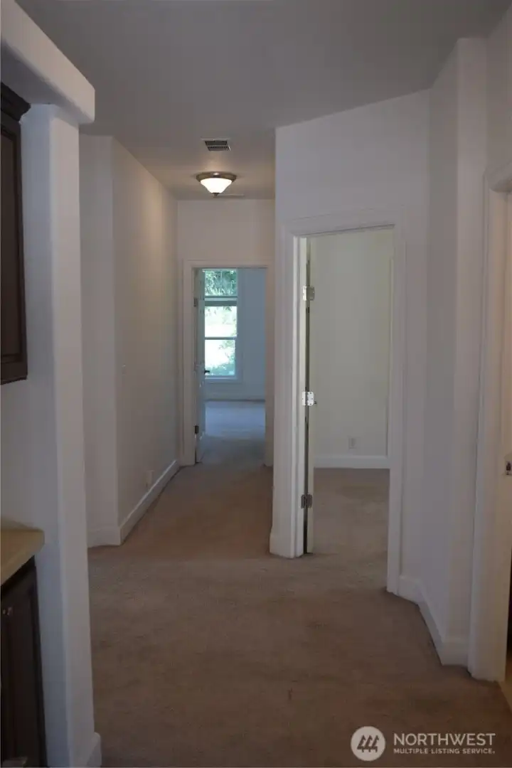 Hallway - Second Bedroom on right. Master Bedroom at End of Hall. Kitchen and Family Room to Left Hallway - Second Bedroom on right. Master Bedroom at End of Hall. Kitchen and Family Room to Left