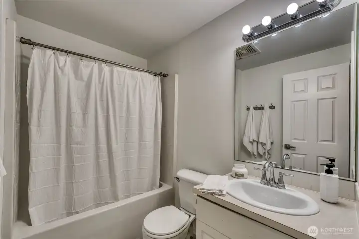 Guest bathroom upstairs is fresh and clean with new flooring and paint. Guest bathroom upstairs is fresh and clean with new flooring and paint.
