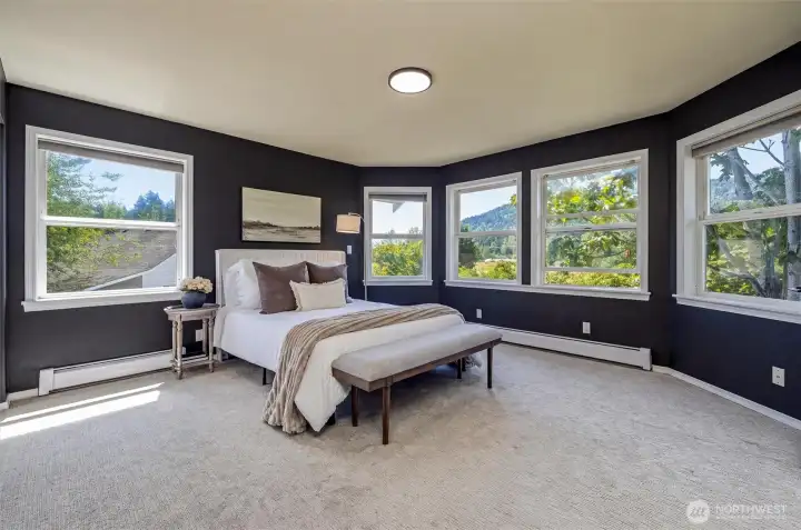 The primary is surrounded by windows to enjoy those beautiful views. The primary is surrounded by windows to enjoy those beautiful views.
