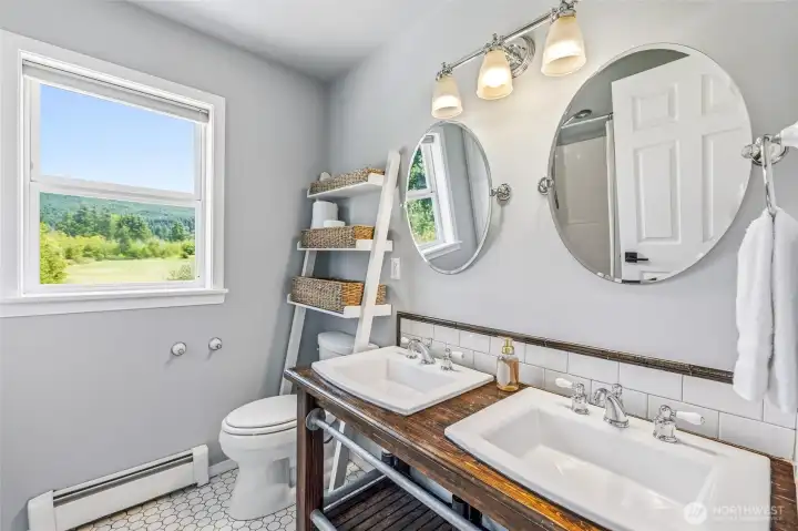 The upper floor shared full bathroom with farmhouse style vanity The upper floor shared full bathroom with farmhouse style vanity